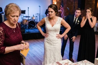 “SIT BY THE KITCHEN DOORS. YOUR FACE WILL RUIN OUR FAMILY PHOTOS.”  So I smiled… slipped the $25,000 check back into my purse… and three hours later, the band went silent, the bar closed, and the flowers disappeared.